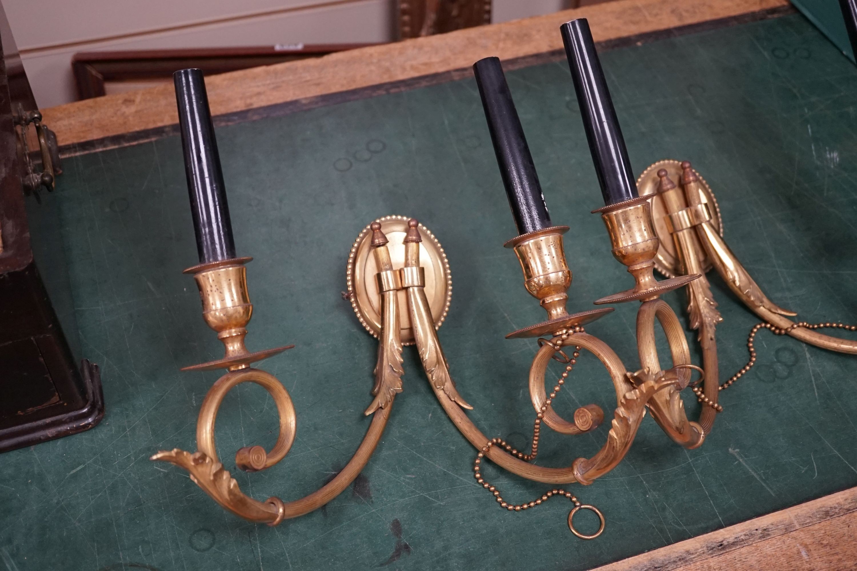 A pair of Adam design brass two branch wall lights